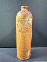 Front view showing full bottle and embossed branding