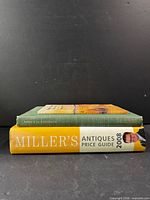 Side view of two stacked hardcover books showing spine thickness and titles