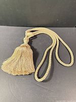 Tieback laid flat showing full length and braid