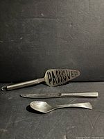 All three stainless pieces: cake server, dinner knife, small spoon