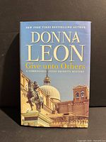 Front cover of Donna Leon Give Unto Others hardcover with dust jacket