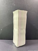 Front view of ribbed light green ceramic vase