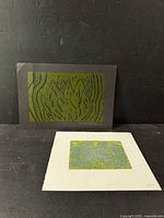 Both prints standing, showing relative sizes and mounting