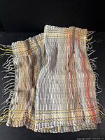 Full view of folded multicolour woven runner rug