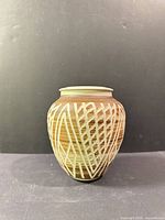 Front view of carved ceramic pot