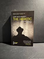 Front cover of The Heretic paperback