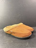 Oblique front view of slippers showing uppers, fleece collar, and soles