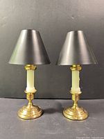 Pair of assembled candlesticks with shades displayed front view