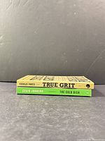 Spine view of both paperbacks showing titles and authors