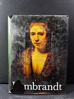 Front view of book with dust jacket showing portrait and title