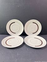 Group view of four matching Wedgwood Prelude saucers