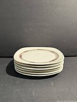 Stack of six Arzberg plates showing quantity and profile