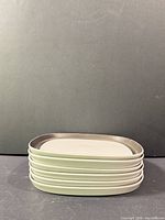 Stacked side view of six square plates