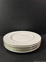 Stack of six dinner plates, side view