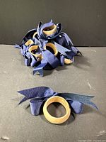 Cluster of wooden napkin rings showing ribbon detail