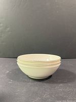 Stack of three Royal Doulton Amulet small bowls showing exterior and silver rim