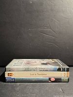 Spine view of three DVD cases stacked: Muriel, Lost in Translation, Babette’s Feast
