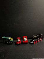 Four toy locomotives side-by-side for scale and variety