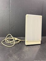 Front three-quarter view of therapy lamp with power cord