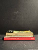 Stack of three Joseph Conrad paperbacks showing spines and size