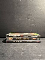 Spines of three DVDs stacked: No Country For Old Men, Collateral, There Will Be Blood