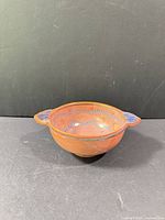 Top angled view showing overall bowl shape, handles, and decoration