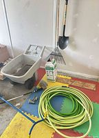 Overall lot with yard cart, rake, shovel, boxed sprayer and coiled hose