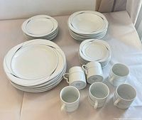 Full lot showing stacks of dinner plates, salad plates, bowls and six mugs