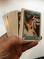Hand holding stacked Topps hockey cards