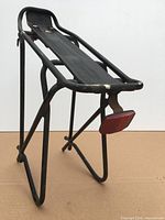 Rear bicycle cargo rack side view on cardboard backdrop