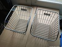 pair of rectangular aluminum bicycle baskets top view