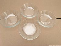 Top view of four clear glass soup bowls