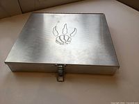 Closed metal case with Raptors logo and latch visible
