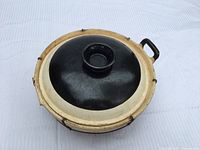 Top view of lidded ceramic pot showing color contrast and missing handle area