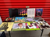 All twelve LP record jackets laid out on table