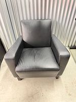 Front view of black leather armchair