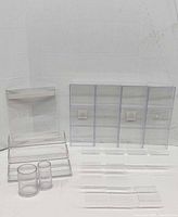 Group shot of all 16 clear acrylic pieces including sign holder, riser, cups, compartment organizer and trays