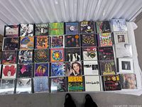 Full lot of approx. 40 CDs laid out showing titles and cover art