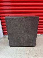 Front view of closed cabinet showing concrete-look finish