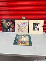 Front covers of all four records displayed upright