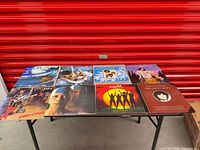 Eight LP record jackets laid out on table