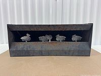 Front view showing four duck targets inside metal shadowbox