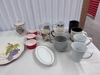 Group shot showing all mugs, ramekins, canister, plates