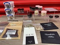 Overview of tapes, tabs, jars of beads, plastic boxes