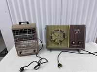 Both heaters side by side showing overall form, grills, cords, handles and size comparison
