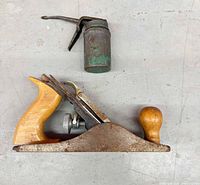 Plane and oil can side by side
