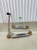 Scooter shown unfolded beside same unit folded to illustrate operational and compact states