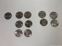 Group shot of all 11 Eisenhower dollar coins laid out for count confirmation