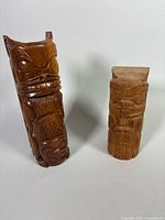 Front view of both wooden totem carvings