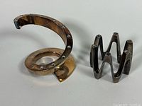 Spiral and crown candleholders side by side